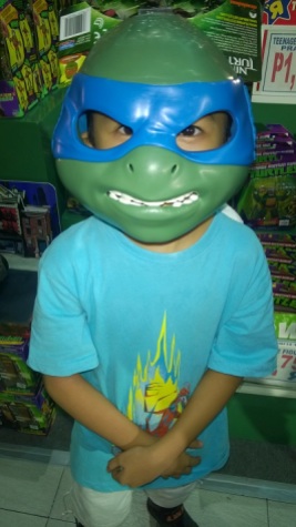 Asher trying on a Leonardo mask on sale.